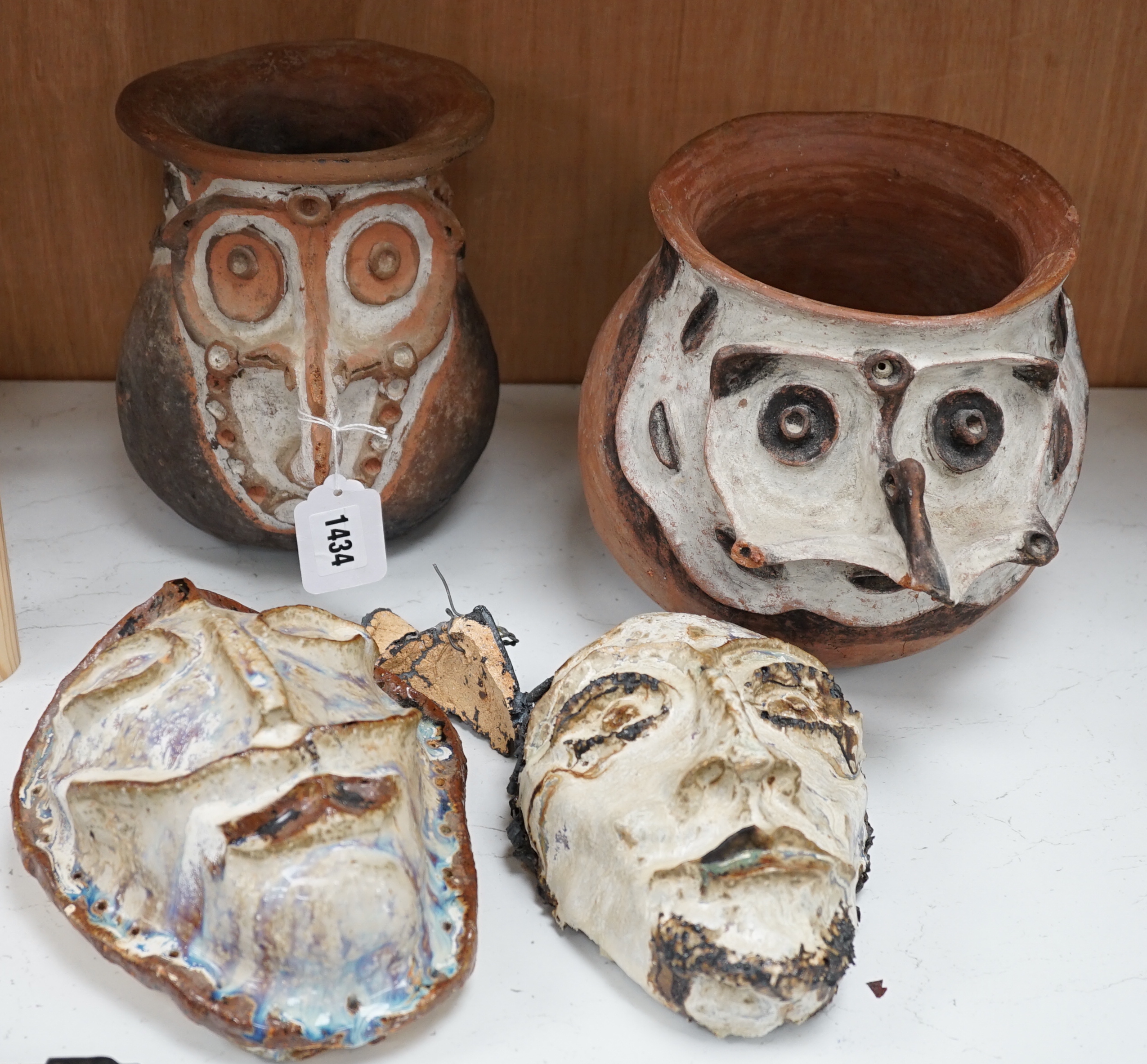 Two Papa New Guinea pottery face masks and two cooking pots